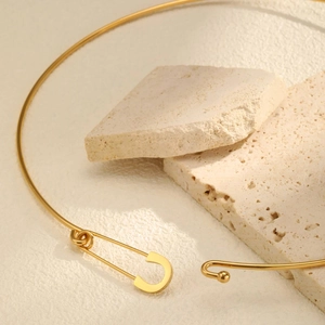Detail of gold-plated stainless steel choker with a clip clasp on travertine stones