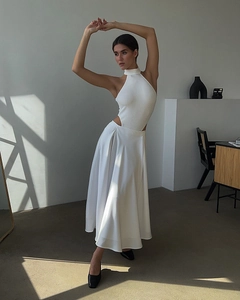 Detail view of a white satin high-waisted midi skirt with a ribbed halter neck top