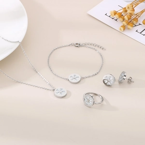 Detailed view of silver stainless steel jewelry set featuring white four-petal flower charms