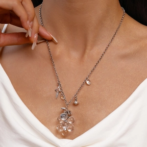 Elegant beaded necklace with transparent grape charms and silver star pendants on model