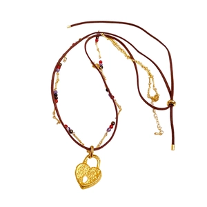 Double-layered leather rope necklace with a vintage gold heart lock pendant and beads