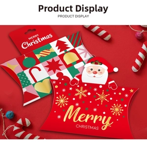 Close-up of creative Christmas pillow boxes for candies with Santa and plaid designs