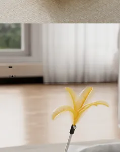 Detail of tumbler cat toy featuring a yellow feather teaser and durable metal spring
