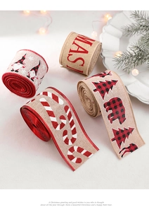Close-up of four Christmas burlap ribbons with festive prints and holiday pine decorations