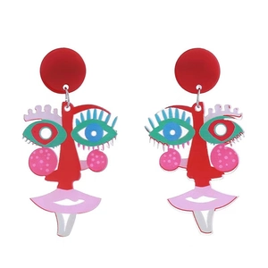 Macro detail of abstract acrylic face earrings with colorful artistic patterns