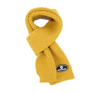 Detailed view of yellow ginger knit scarf with pineapple texture and bear logo patch
