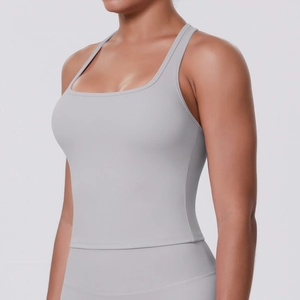 Detail view of the light grey athletic tank top showing racerback and moisture-wicking fabric