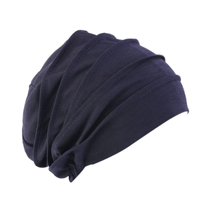 Detailed view of dark blue pleated sleep cap with soft cotton texture for hair loss