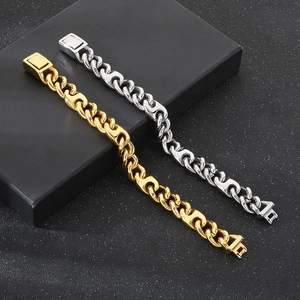 Detail of gold and silver cuban link bracelets displayed on black jewelry box