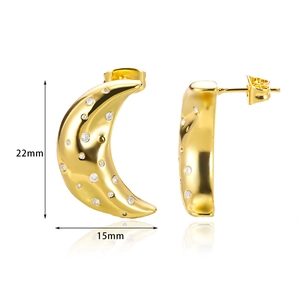 Detail view of gold moon-shaped earrings with white zircon stones and size dimensions