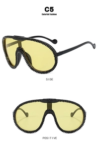 Detail of yellow oversized cycling sunglasses with crystal-embellished frames and black temples