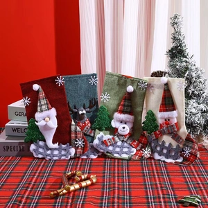 Four large plaid Christmas stockings with Santa, Reindeer, Bear, and Snowman appliques