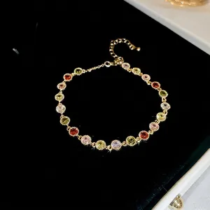 Elegant gold plated bracelet featuring colorful round cubic zirconia and adjustable chain