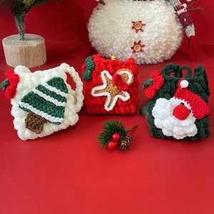 Detailed view of hand-crocheted Christmas mini bags with festive gingerbread man patterns