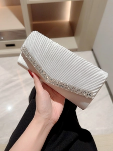 Elegant white pleated evening clutch with rhinestone detailing and versatile chain strap