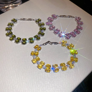 Detail view of oval zircon bracelets in olive green, pink purple and yellow stones