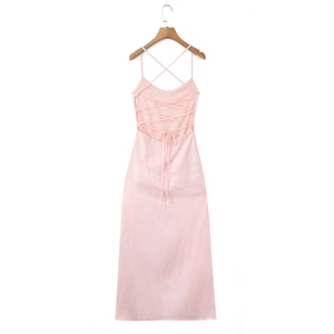 Detail view of pink satin dress featuring cross lace-up open back and thin shoulder straps