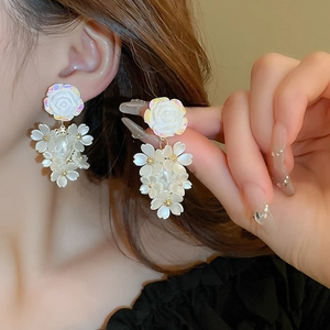 Elegant acrylic flower tassel earrings with white pearls for women on model view