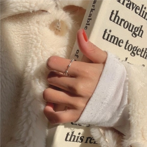 Detailed view of minimalist 925 sterling silver beaded ring worn on a finger