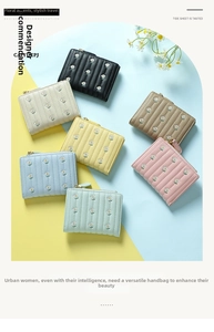 Flat lay of small women's wallets with floral embroidery in seven pastel colors