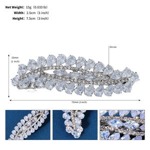 Macro details of silver feather hair clip with zircon stones and size specifications