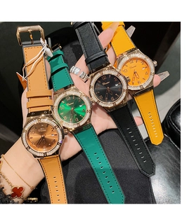 Close-up of diamond-encrusted women's watches in brown green black and yellow leather bands