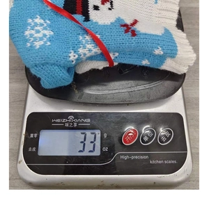 Detail of blue and white knitted Christmas wine bottle cover on a weighing scale