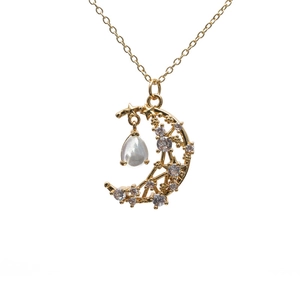 Gold crescent moon and star pendant necklace with crystal and opal drop on white background