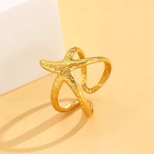 Macro shot of gold starfish ring featuring hammered metal texture and adjustable open band