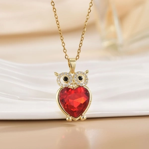 Gold owl necklace featuring a vibrant red heart crystal and sparkling zircon eyes