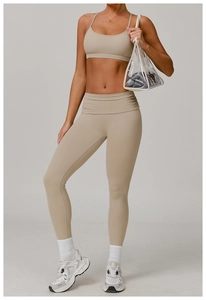 Close-up of high-waisted yoga leggings and sports bra set in beige stretch fabric
