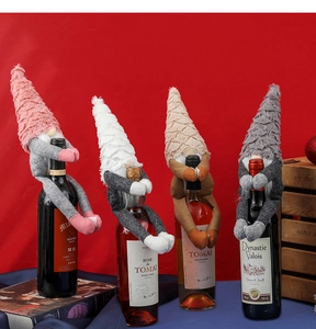 Detail of four festive gnome wine bottle covers in pink, white, brown and grey colors