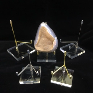 Clear acrylic display stands with gold and silver metal arms for crystals and minerals