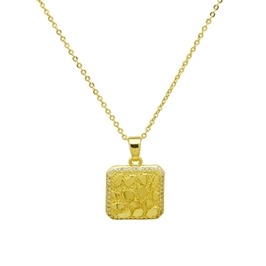 Close-up of gold-plated square pendant featuring irregular pebble texture and zircon edges