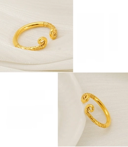 Macro detail of 18K gold plated stainless steel ring with vintage cloud pattern engraving
