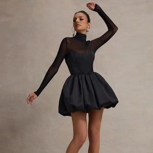 Detail of elegant black mini dress featuring sheer mesh long sleeves and puffy bubble hem