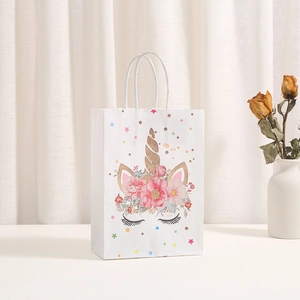 Detailed view of white unicorn gift bag with gold stamping and floral patterns