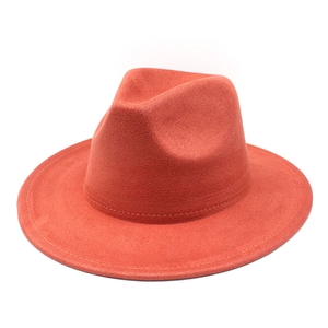Detailed top view of an orange suede fedora hat with classic brim stitching