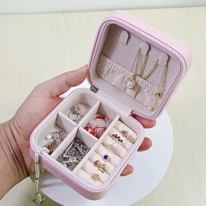 Pink portable travel jewelry organizer box with compartments for rings and necklaces