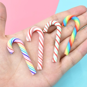 Miniature Christmas candy cane charms in rainbow and striped resin for DIY crafts