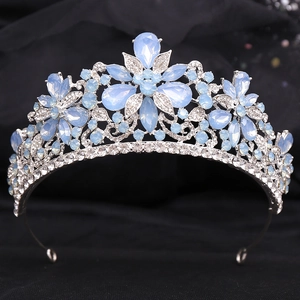 Detail of silver alloy crown featuring light blue teardrop stones and sparkling crystals
