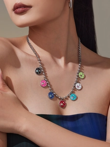 Detail of colorful celestial enamel charms on a mixed link stainless steel necklace