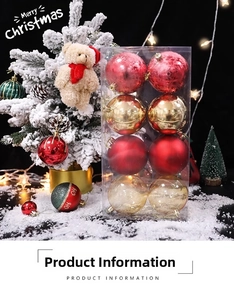 Detail of red and gold Christmas ornaments set in transparent box on snowy background