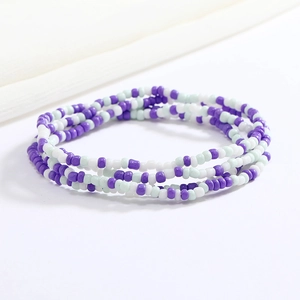 Detailed macro view of colorful purple, white and mint green beaded elastic waist chain