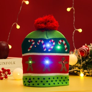 Detail of LED knitted Christmas hat featuring gingerbread pattern and light switch button