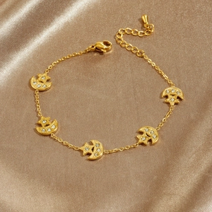 Gold star and moon pendant bracelet with sparkling rhinestones on champagne satin fabric