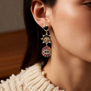 Detailed macro shot of vintage three-tier drop earrings with colorful zircon and enamel