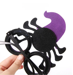Rear detail of Halloween party glasses with felt spider and witch hat decorations