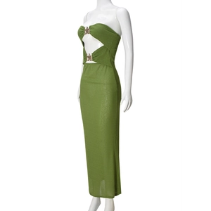 Close-up of side cutout detail with gold metal buckle on a green bodycon maxi dress