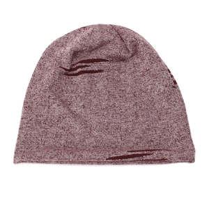 Close-up of a burgundy heathered knitted beanie hat with distressed ripped design